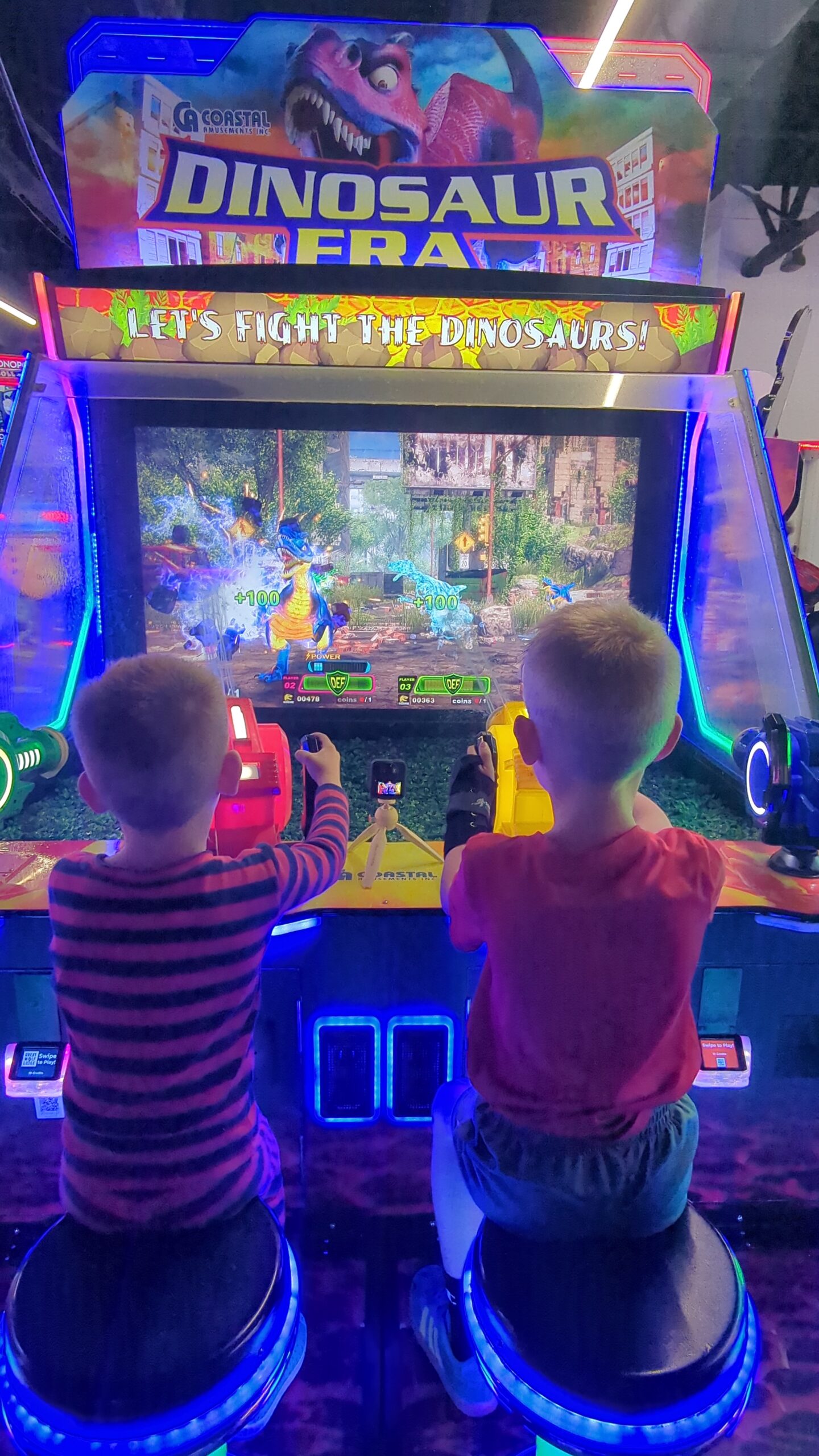 My two boys playing video games at the arcade at the Great Wolf Lodge